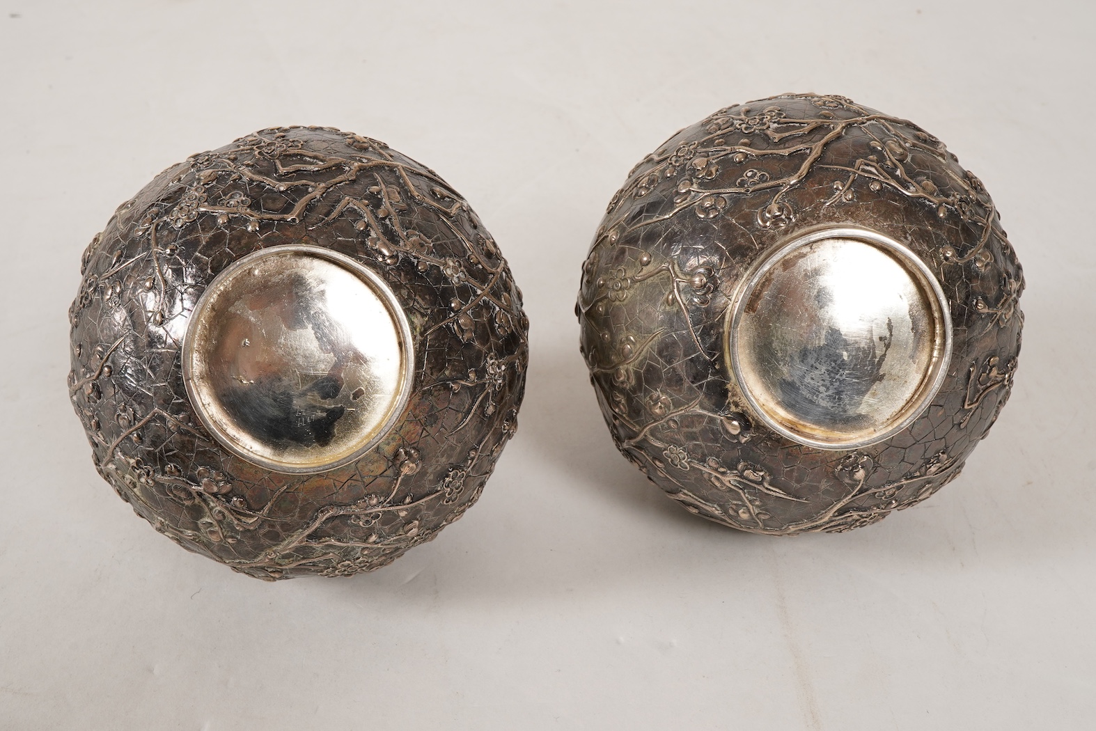 A pair of late 19th/early 20th century Chinese Export white metal two handled globular vases, by Wang Hing, Hong Kong